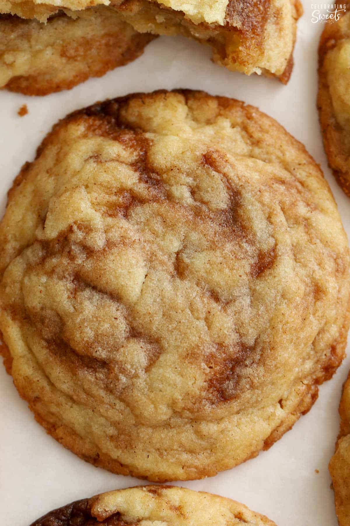 Closeup of a cinnamon roll cookie on parchment paper.