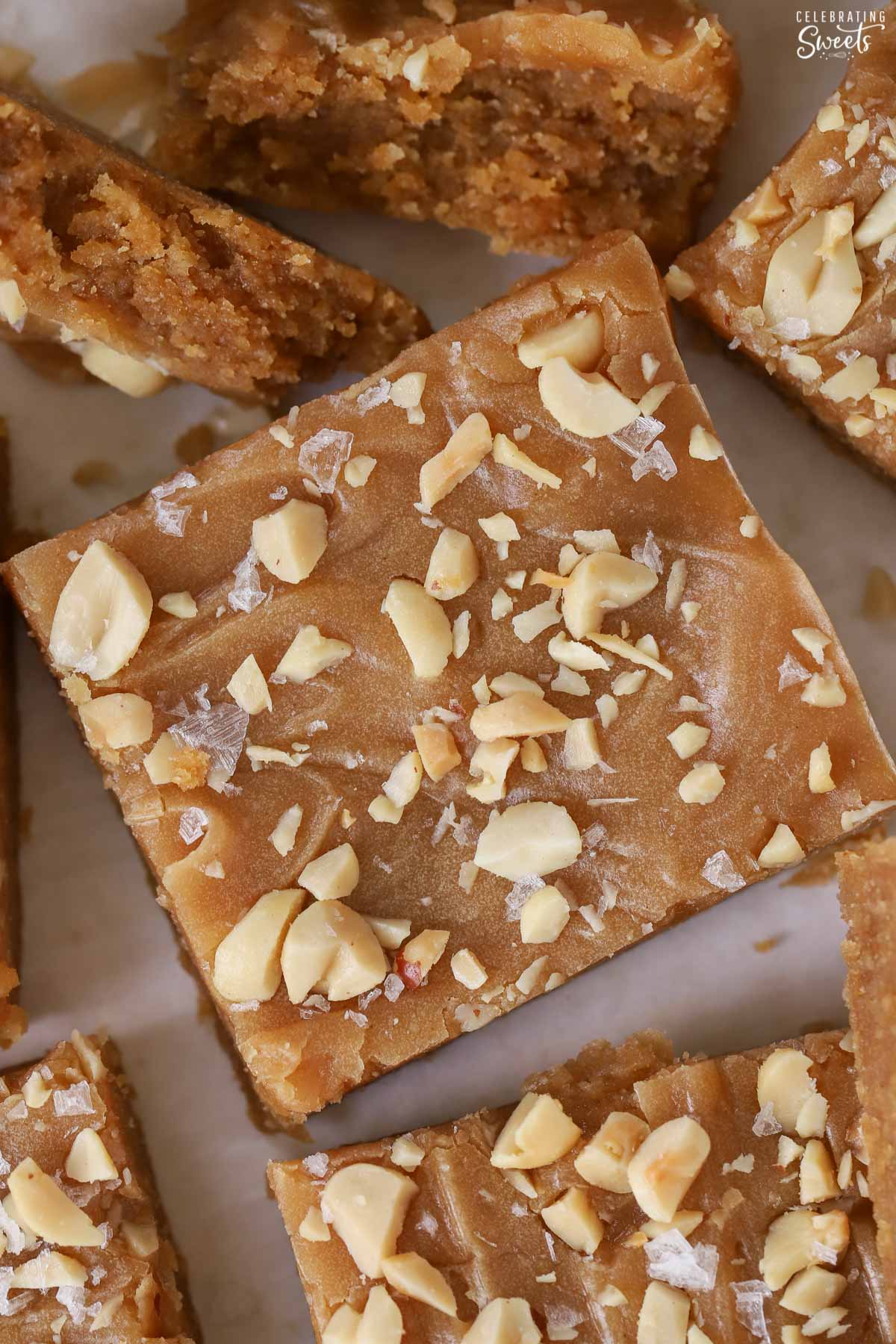 Peanut butter bar topped with peanut butter icing, peanuts, and sea salt.