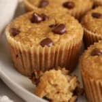 Banana oatmeal muffins topped with chocolate chips on a grey plate,