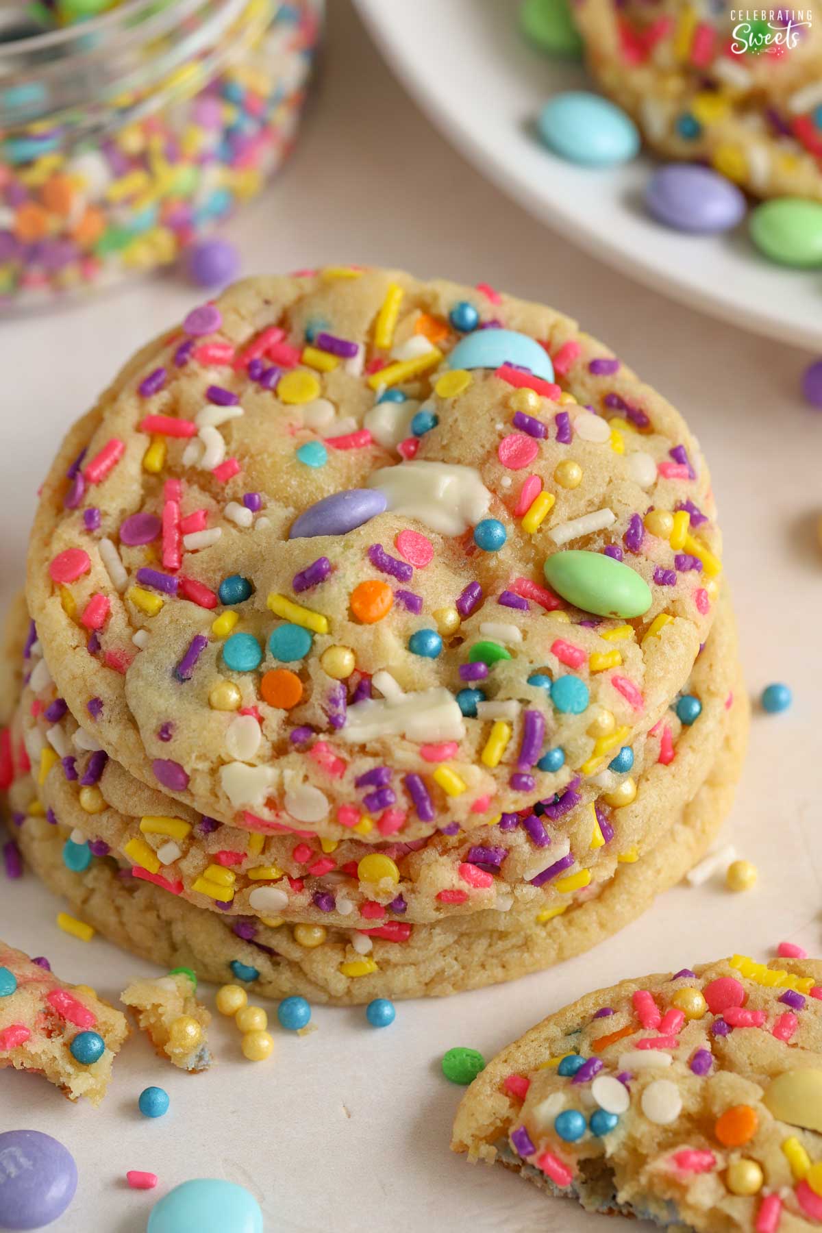 Stack of three cookies topped with pastel M&M's and sprinkles.