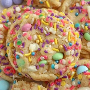 Closeup of cookies topped with pastel M&M's and sprinkles.