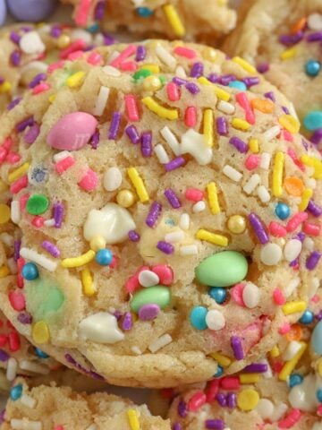 Closeup of cookies topped with pastel M&M's and sprinkles.