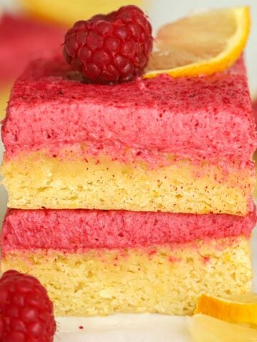 Two raspberry lemon bars stacked on top of each other.