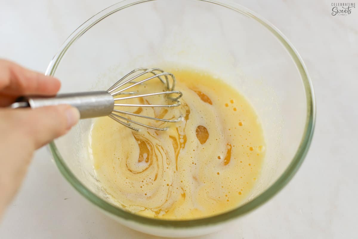 Small batch vanilla cupcake batter in a glass bowl with a small whisk.