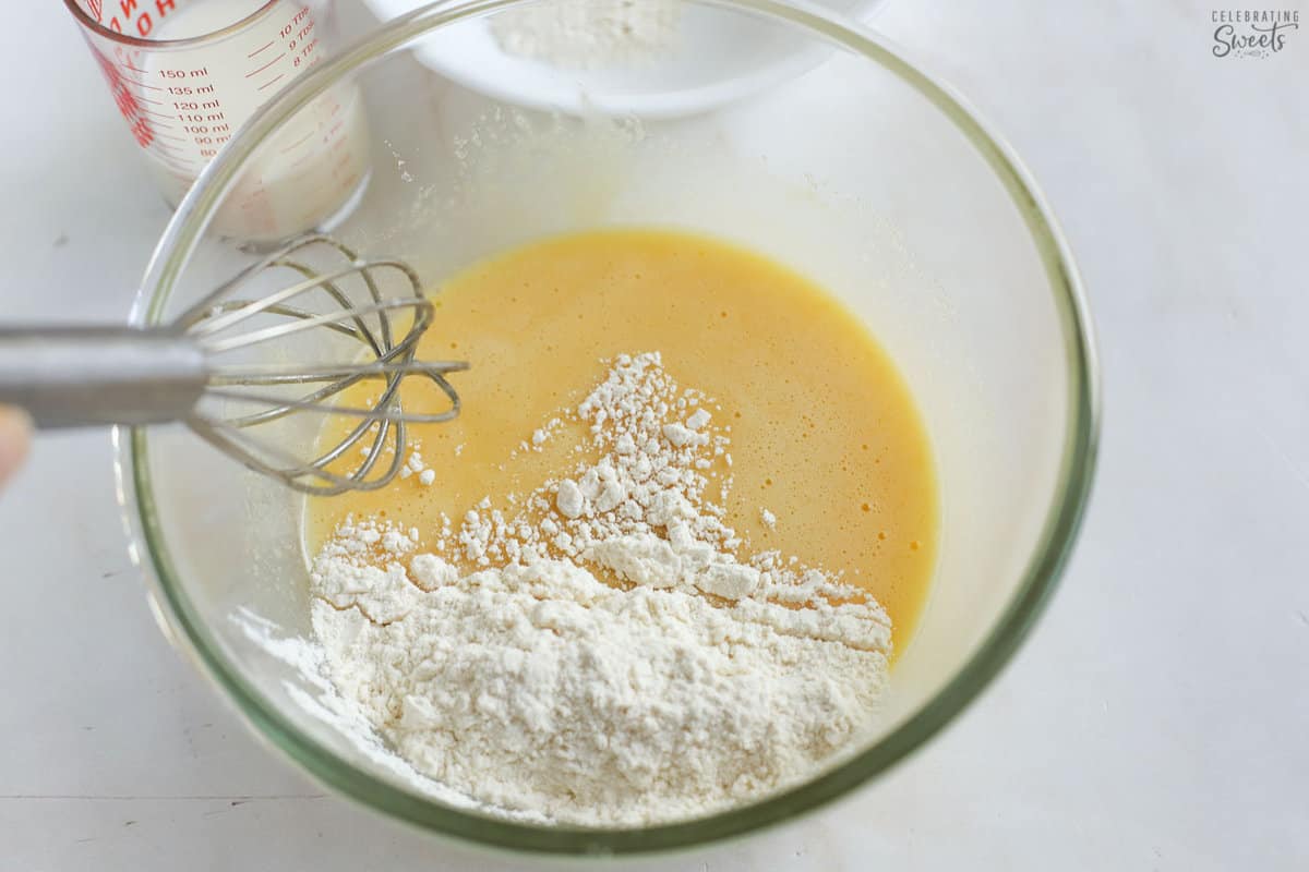 Small batch vanilla cupcake batter in a glass bowl with a small whisk.