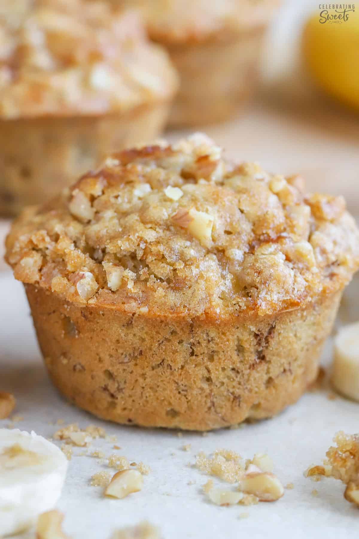 Banana nut muffin topped with brown sugar and nuts.