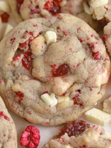 White chocolate raspberry cookie on a piece of parchment paper.