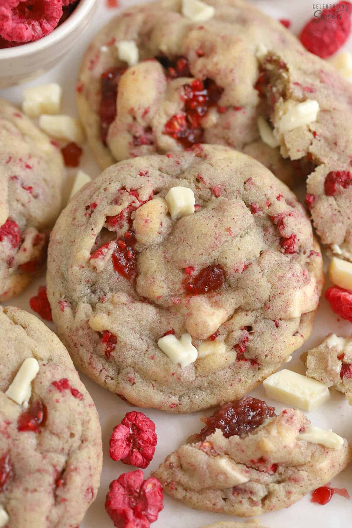 White chocolate raspberry cookies on a piece of parchment paper.