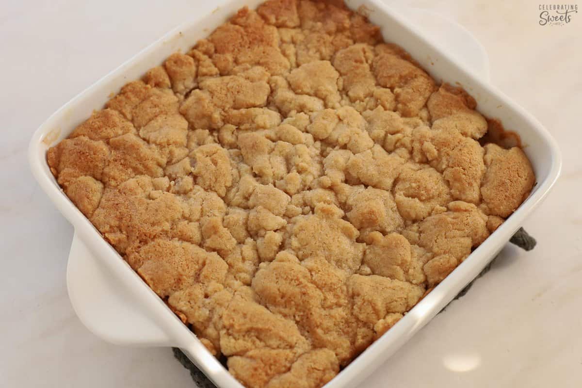 Apple cobbler in a white square baking dish.