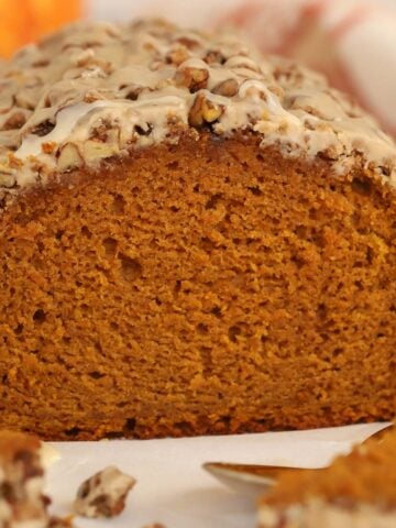 Loaf of pumpkin bread on parchment paper.