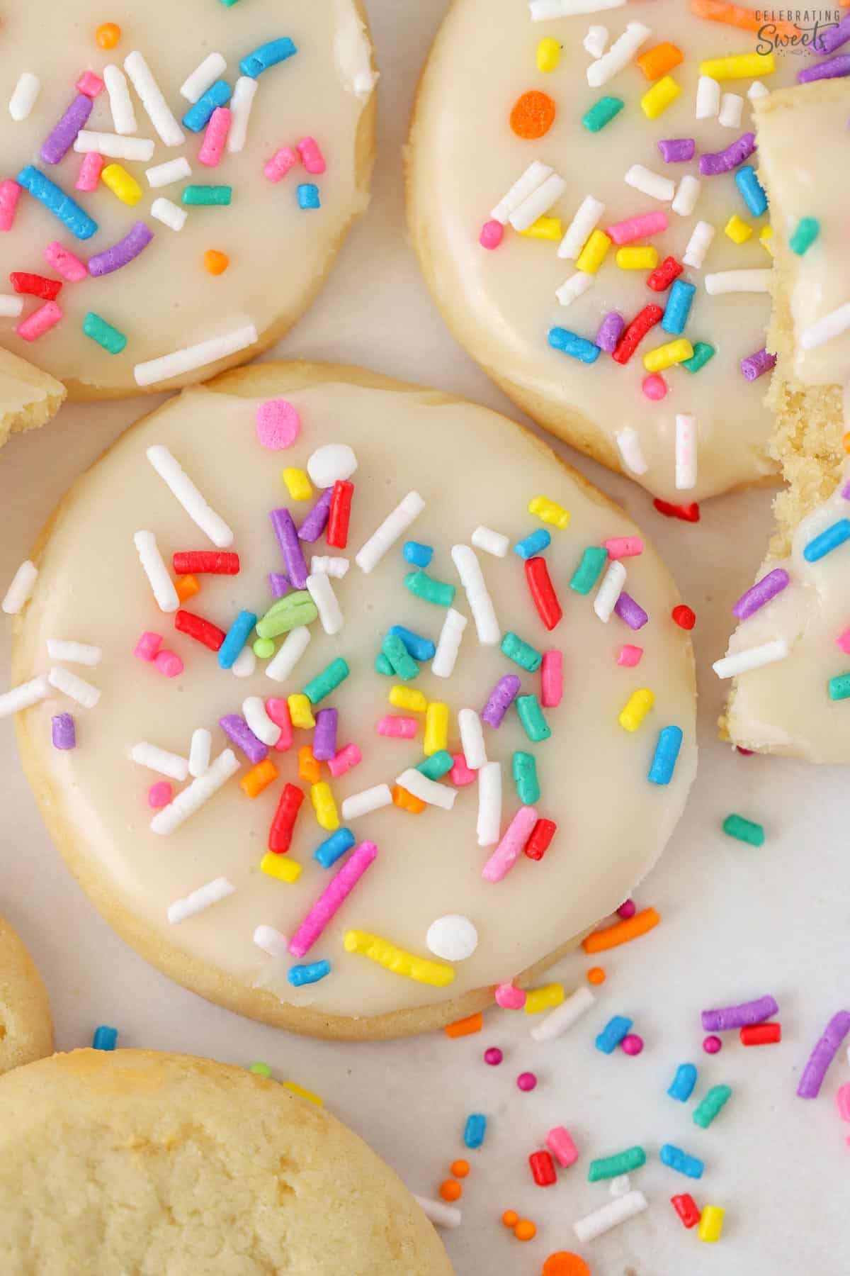 Sugar cookie topped with sugar cookie frosting and rainbow sprinkles.