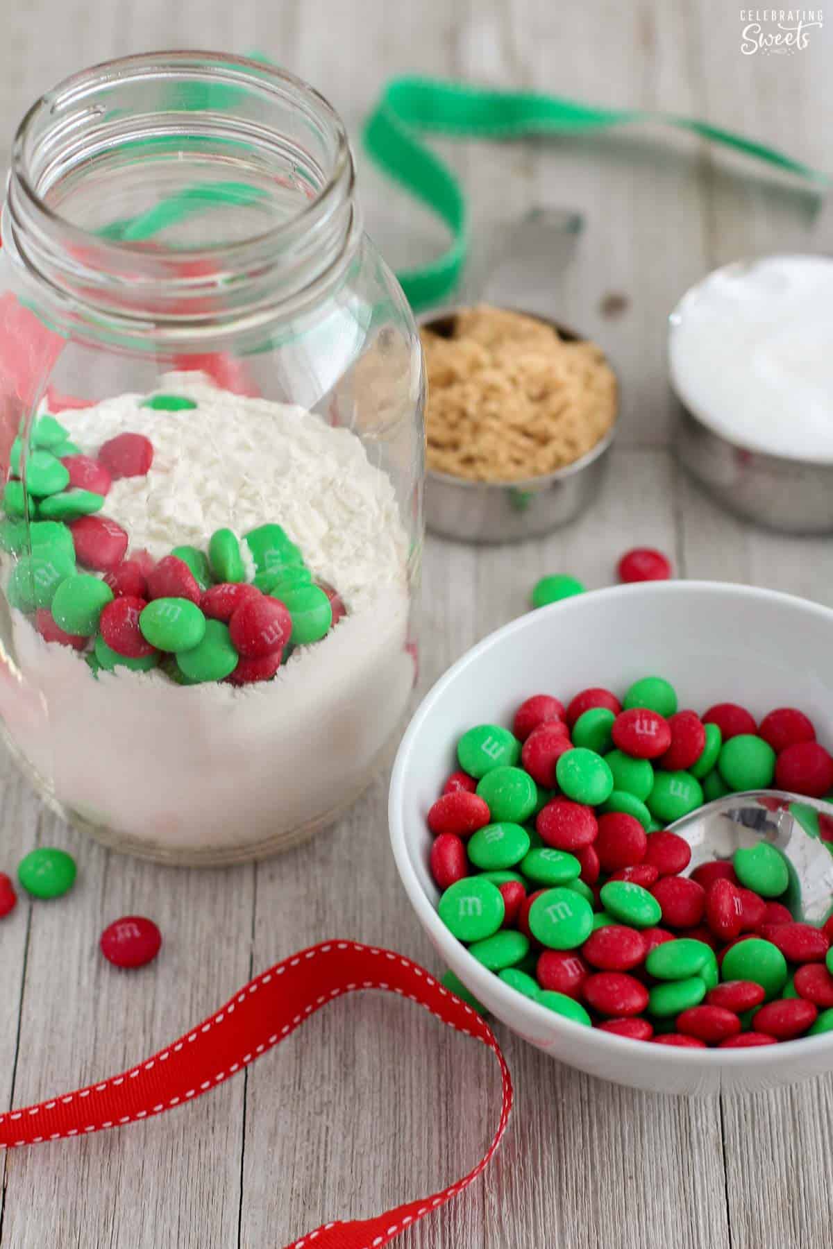 Assembling M&M cookie mix in a jar.