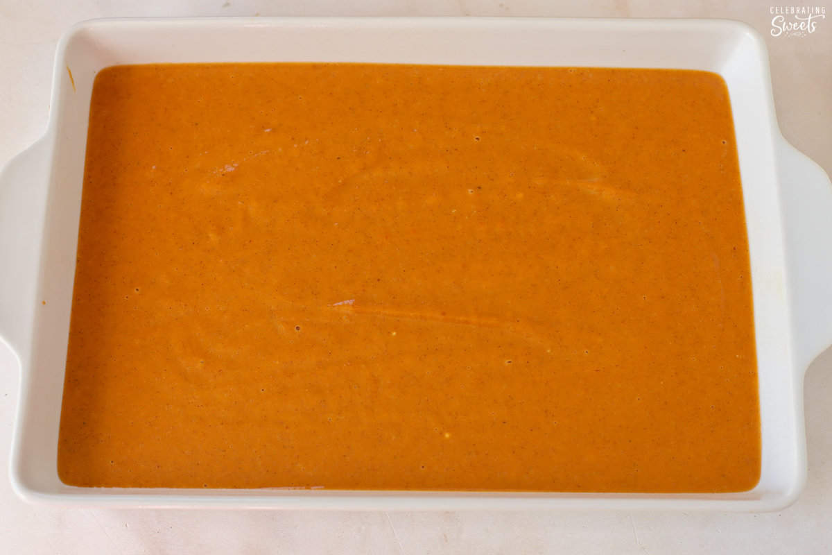 Pumpkin crisp filling in a white rectangular baking dish.