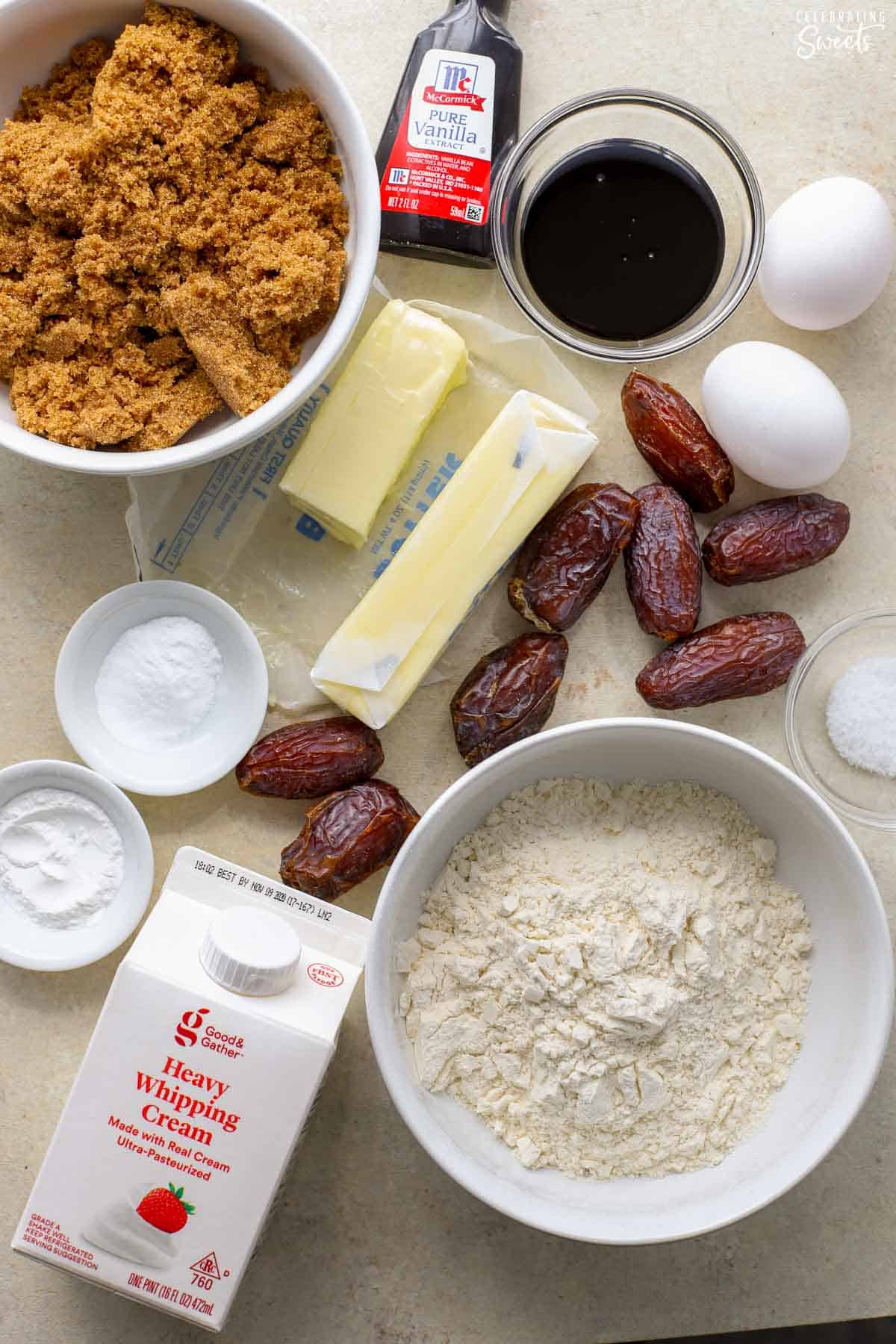 Ingredients to make sticky toffee pudding (cream, flour, dates, butter, eggs, brown sugar, vanilla).