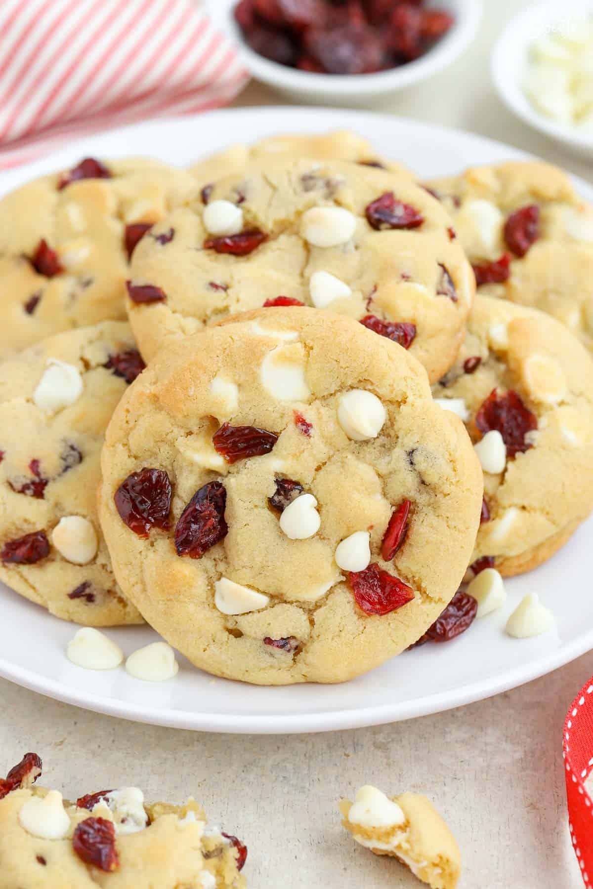 White chocolate cranberry cookies on a white plate.