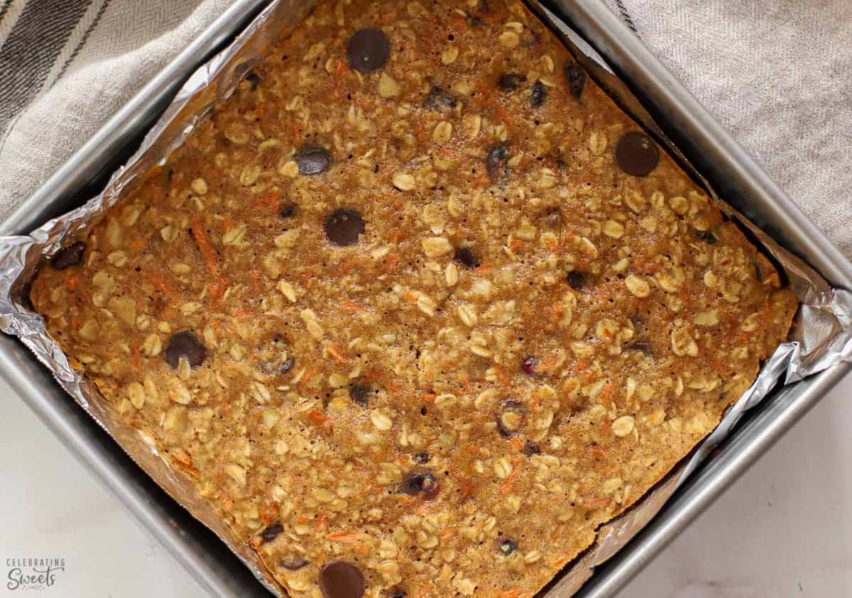 Breakfast bars in a square pan lined with foil.