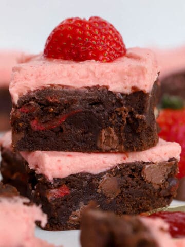 Two strawberry brownies stacked on top of each other.