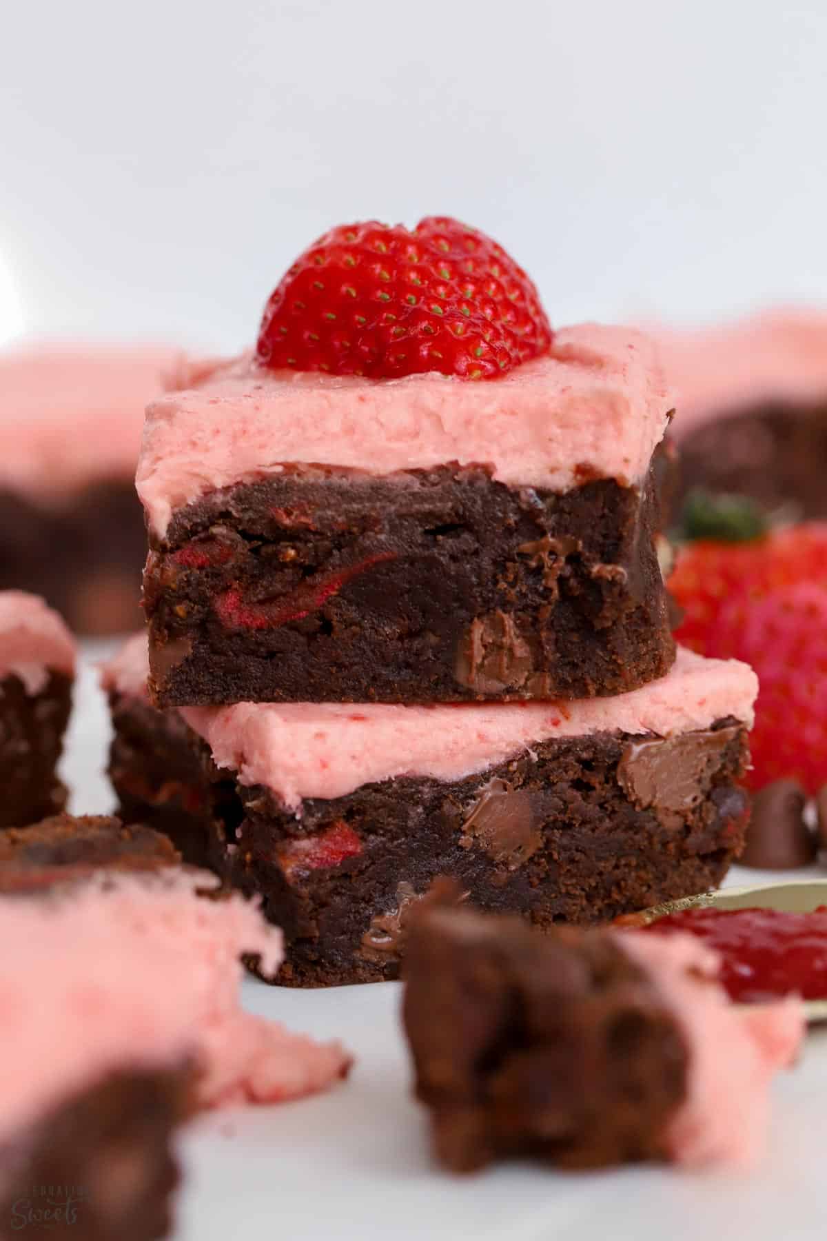 Two strawberry brownies stacked on top of each other.