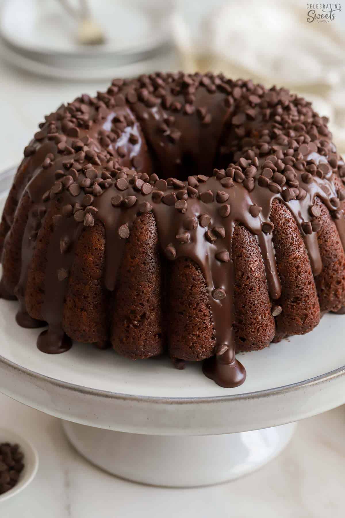 Chocolate bundt cake on a grey cake stand.