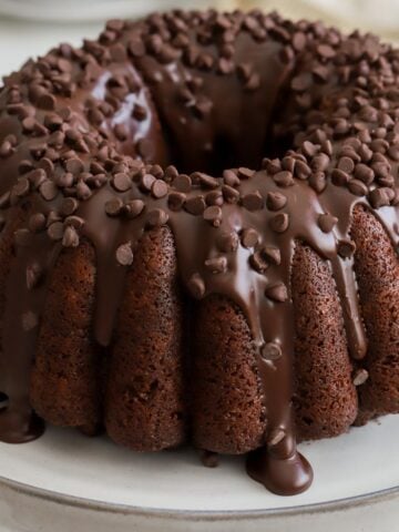 Chocolate bundt cake on a grey cake stand.