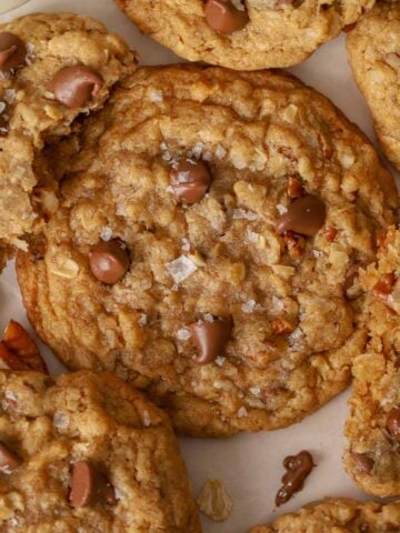 Closeup of a cowboy cookie topped with chocolate chips and flaky salt.