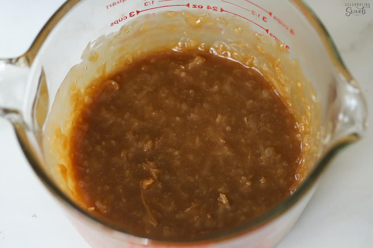 Caramel coconut sauce in a glass measuring cup.