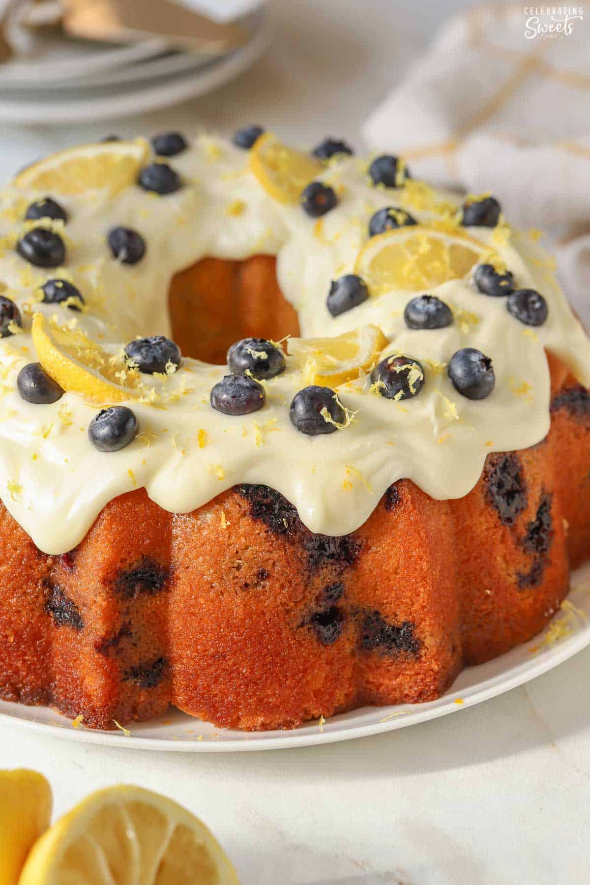 Lemon blueberry bundt cake on a white plate.