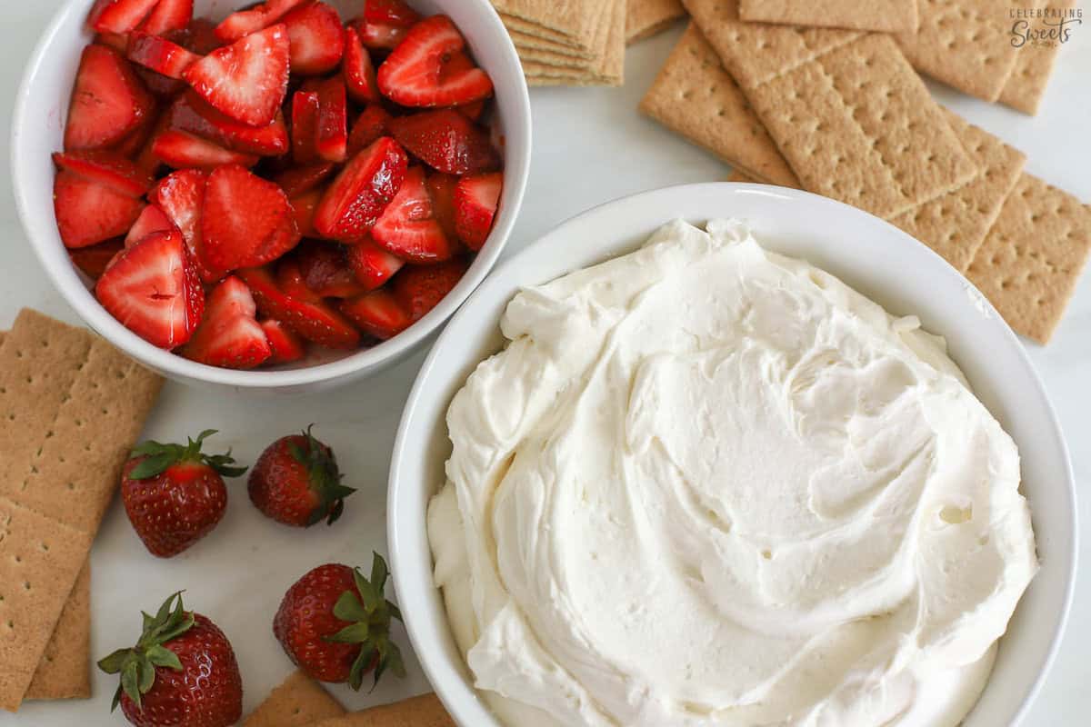 Whipped cream, sliced strawberries, and graham crackers.