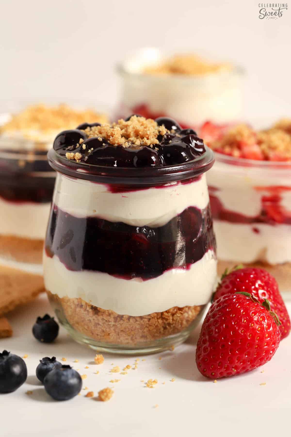 Cheesecake parfait with blueberry sauce layered in a glass jar,