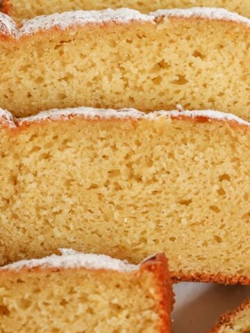 Slices of yogurt cake on a white plate.