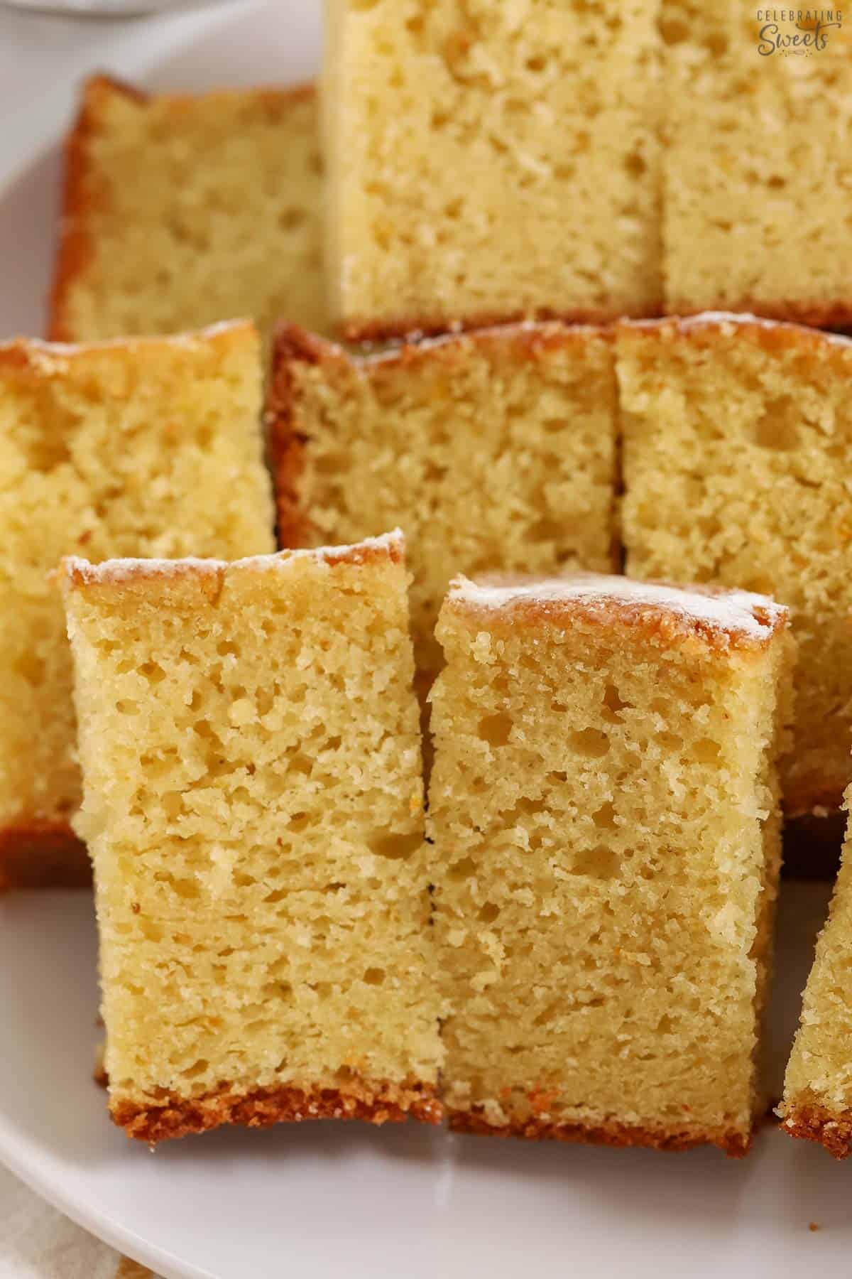 Closeup of slices of yogurt cake on a white plate.