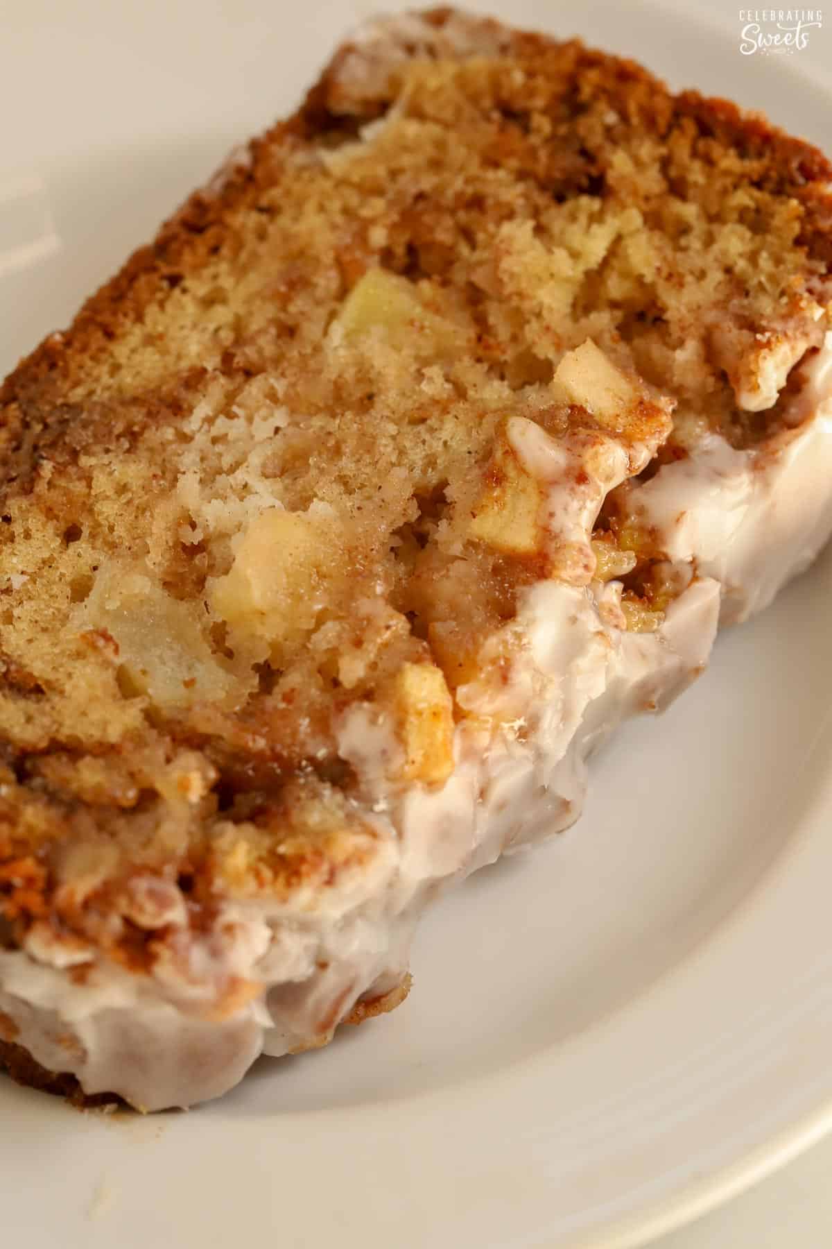 One slice of apple fritter bread on a white plate.