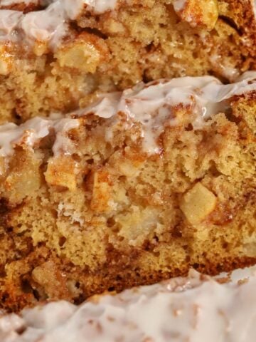 Closeup of three slices of apple fritter bread.