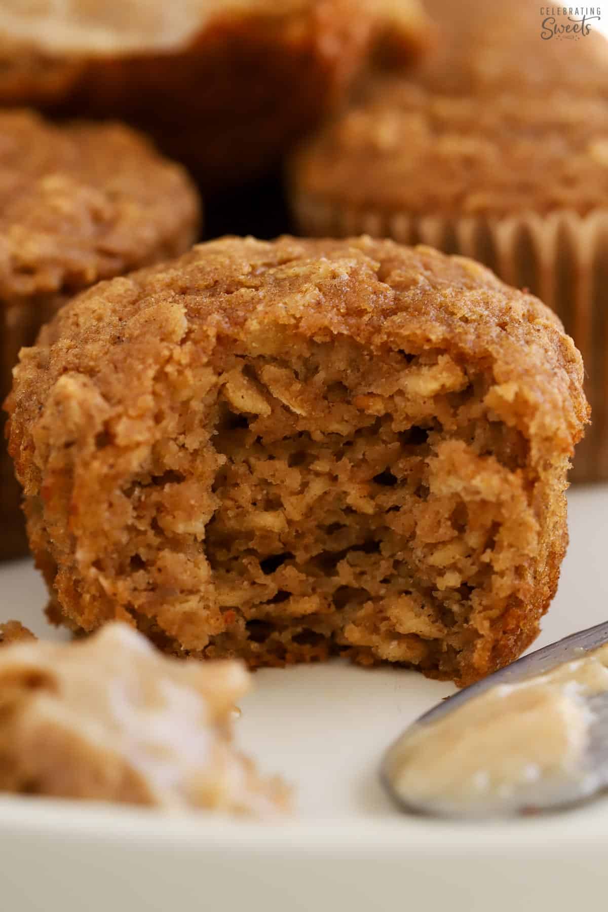 An apple oatmeal muffin with a bite taken out of it.