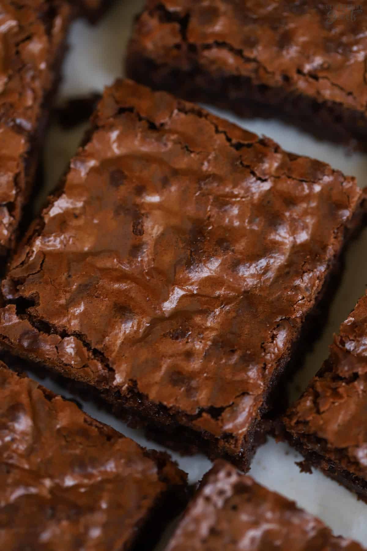 Closeup of a chewy brownie with shiny, crinkly top.