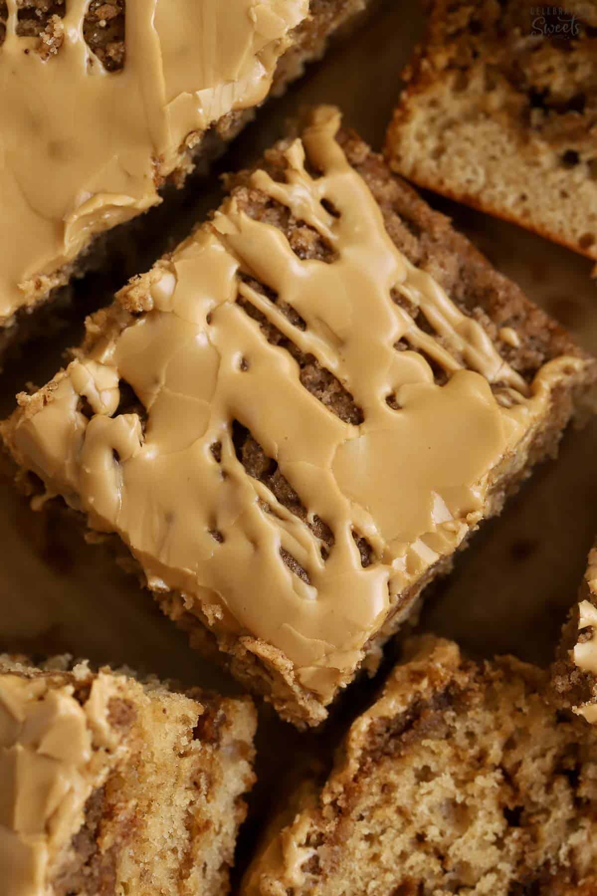 Slice of crumb cake topped with beige icing.