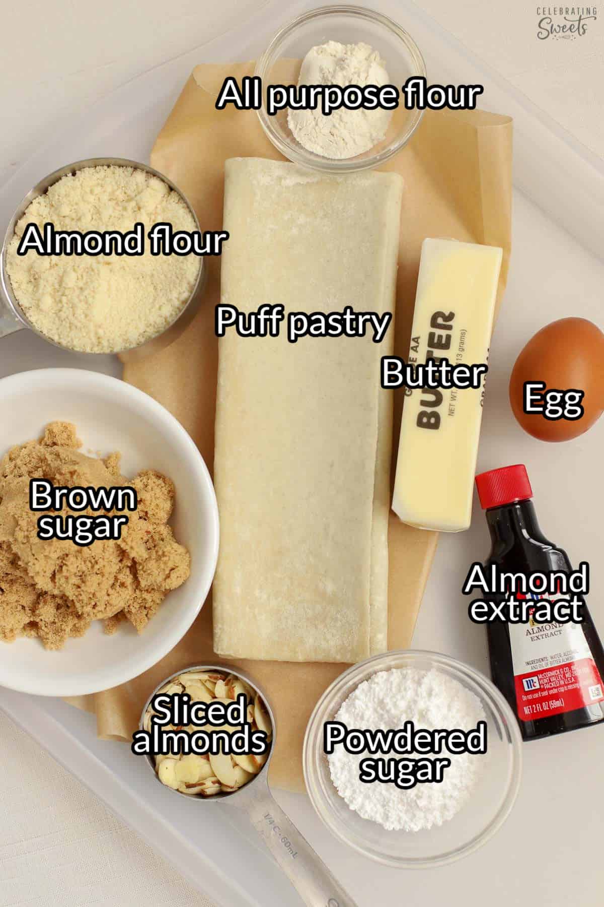 Ingredients (with text overlay): puff pastry, flour, brown sugar, egg, almond extract, sliced almonds, powdered sugar, butter.