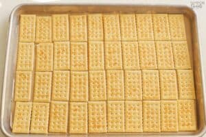 Club crackers in a single layer on a baking sheet.