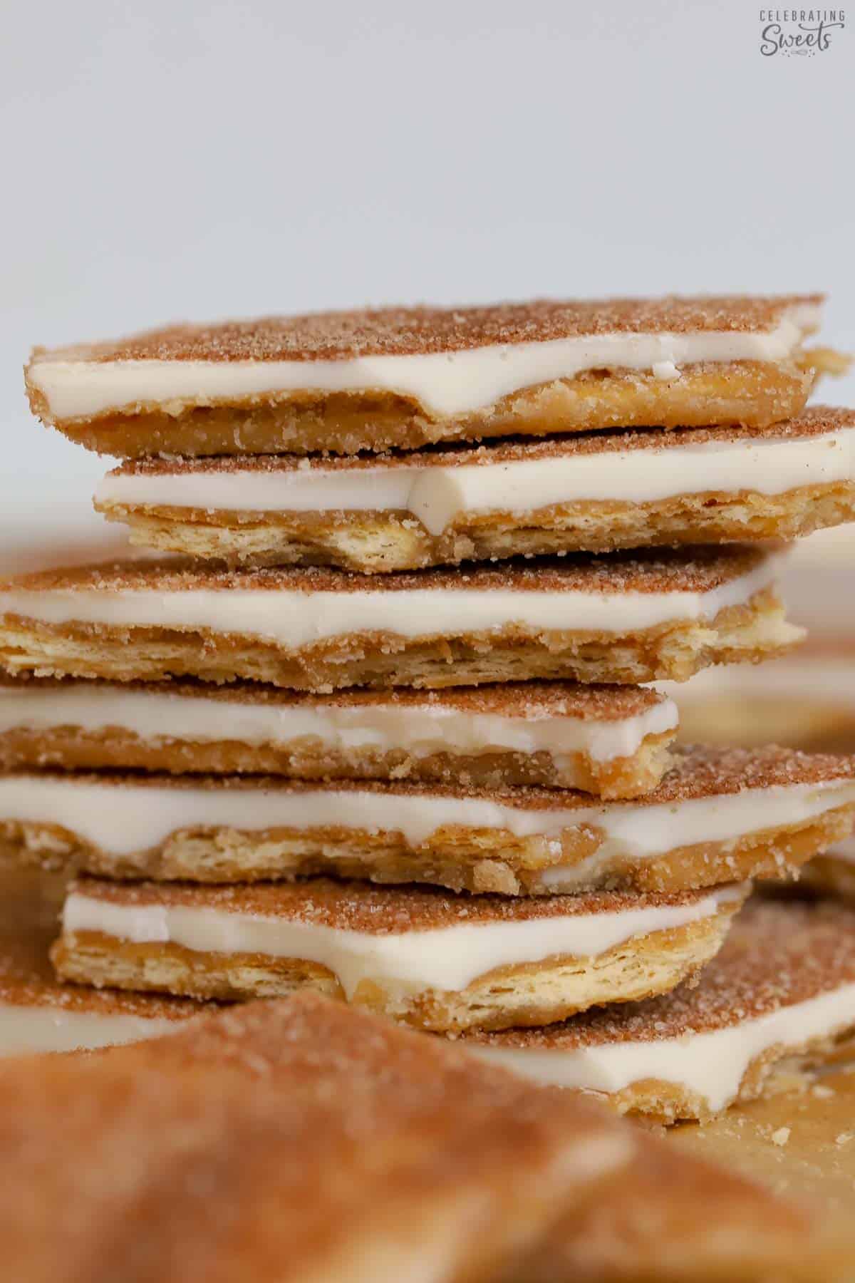 6 pieces of churro toffee stacked on a baking sheet.