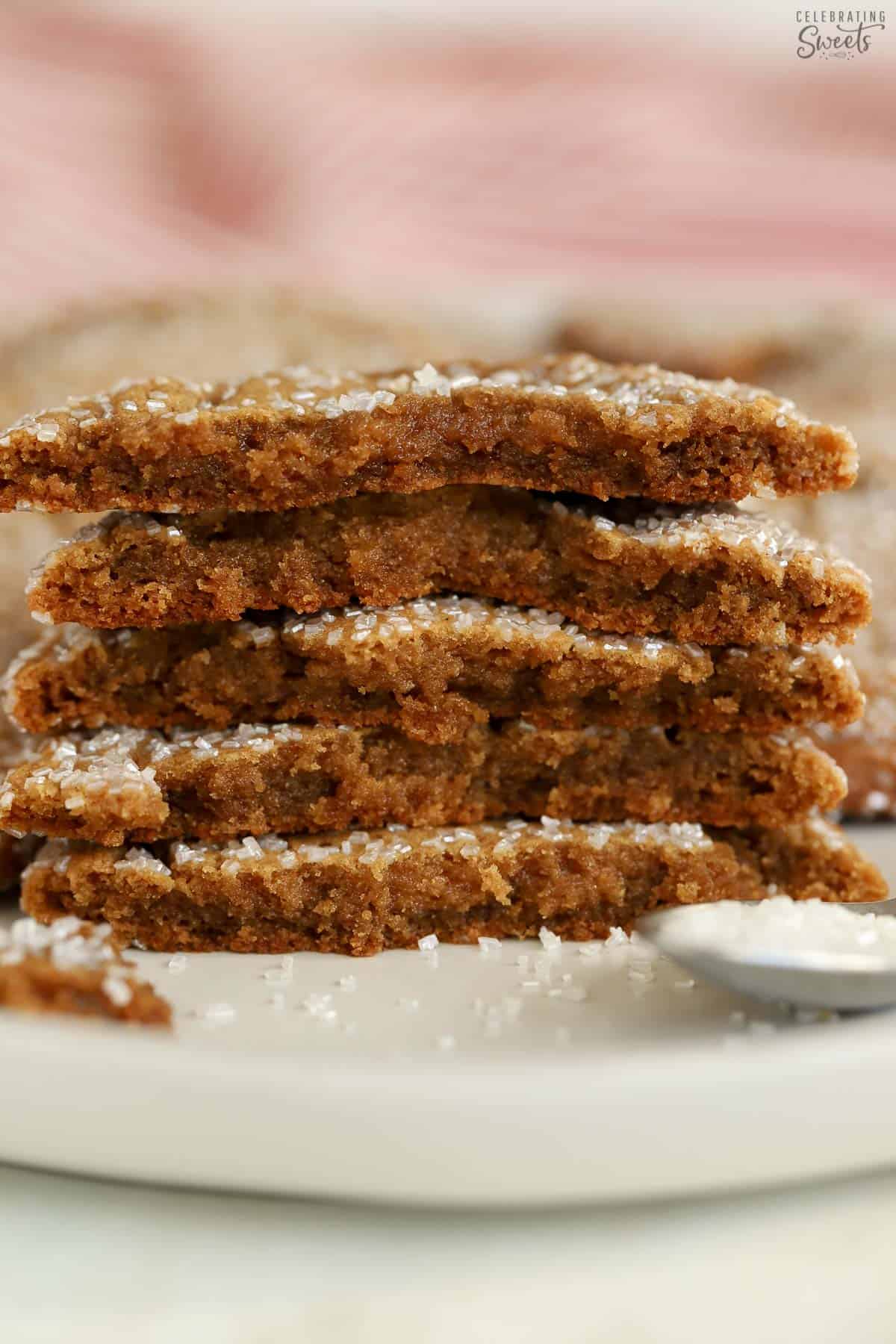 Stack of five halved ginger molasses cookies on a white plate.