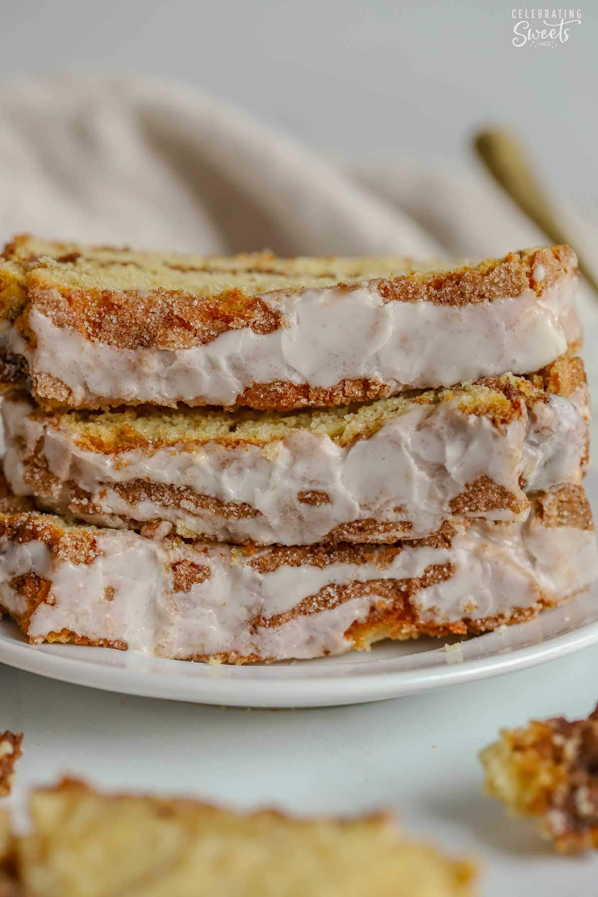 Stack of three slices of cinnamon bread on a white plate.