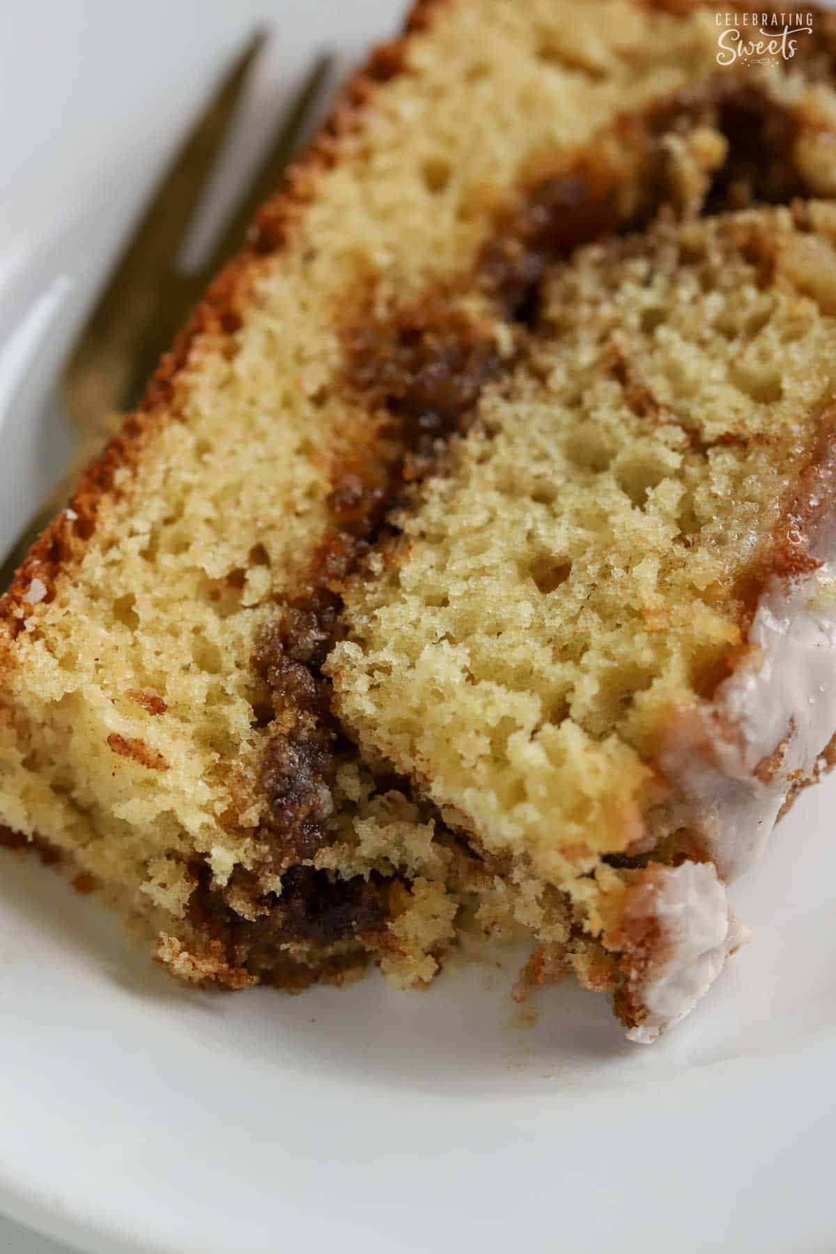 Close up of a slice of cinnamon swirl bread on a white plate.