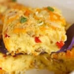 A serving of egg casserole on a purple spatula.