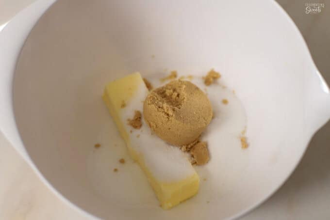 Butter and sugars in a white bowl.