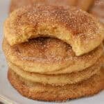 Stack of four snickerdoodle cookies on a grey plate.