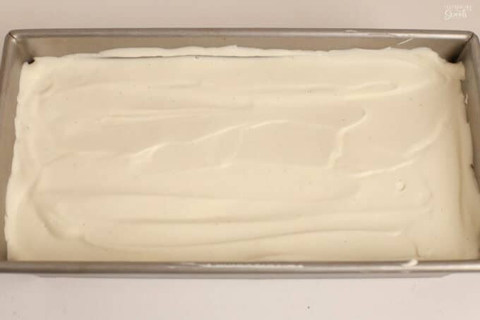 Vanilla ice cream in a rectangular metal loaf pan.
