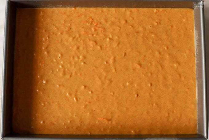Pumpkin carrot cake batter in a rectangular cake pan.
