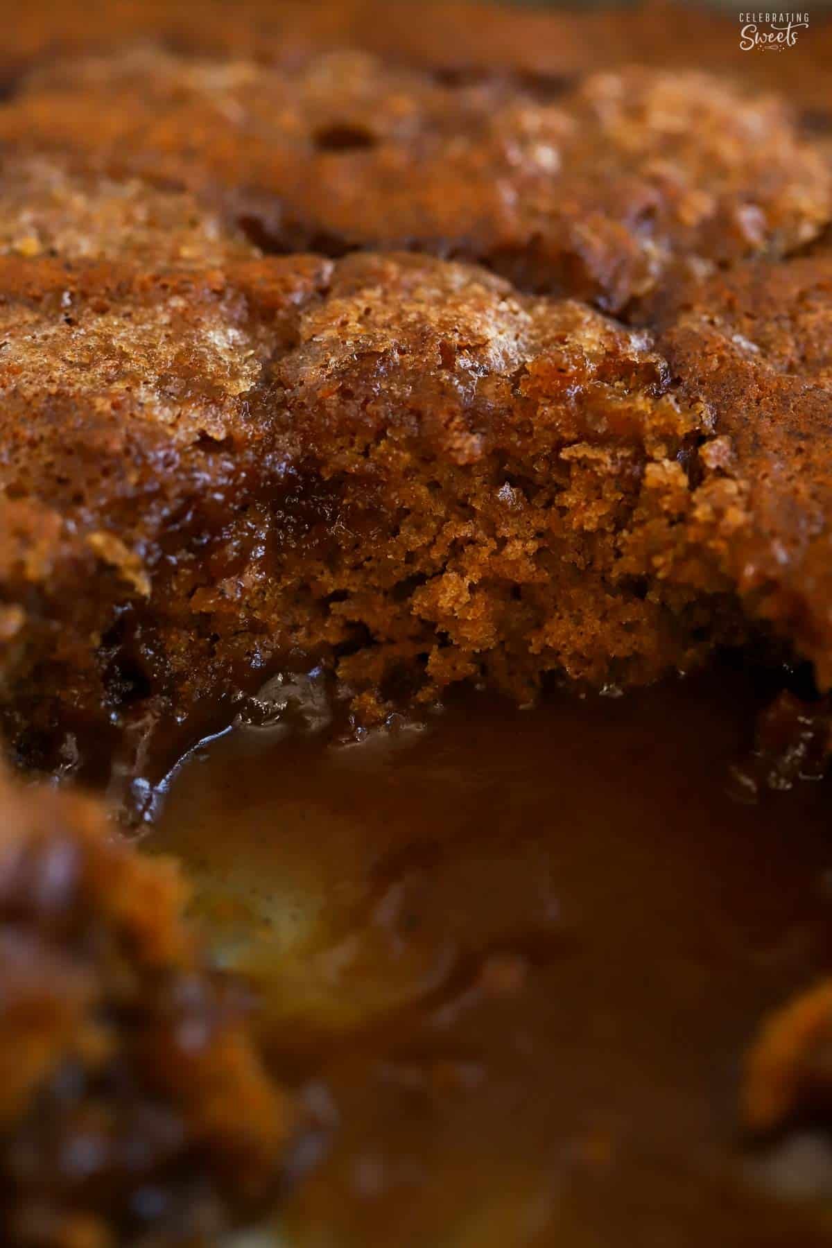 Closeup of pumpkin pudding cake in a baking pan with caramel sauce on the bottom.