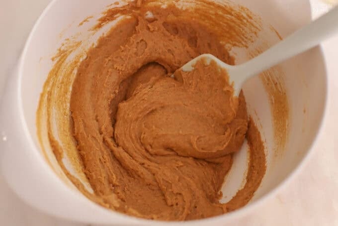 Pumpkin cake batter in a white bowl.