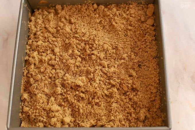 Cake batter topped with brown sugar in a square pan.